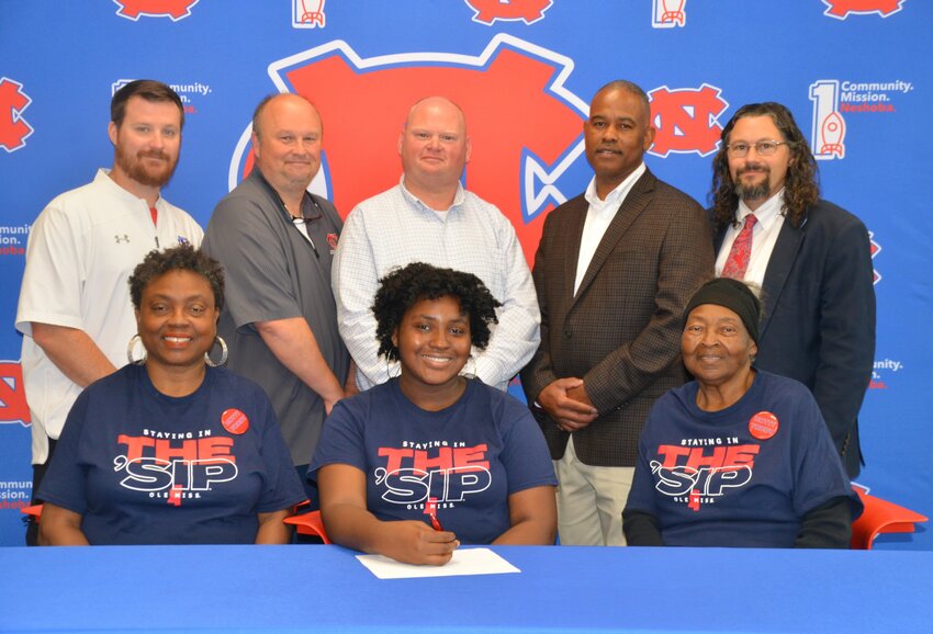 Neshoba Central’s Emmaly Watson signed with the University of Mississippi to further her education and be a member of The Pride of the South. Pictured, front row from left, are her mother Lisa Watson, Emmaly Watson and grandmother Annie Fulton (Back) Asst. Principal Jonathan Walker,  Principal Jason Gentry, Assistant Principal Brent Pouncy Assistant Principal LaShon Horne, and Band Director Daniel Wade